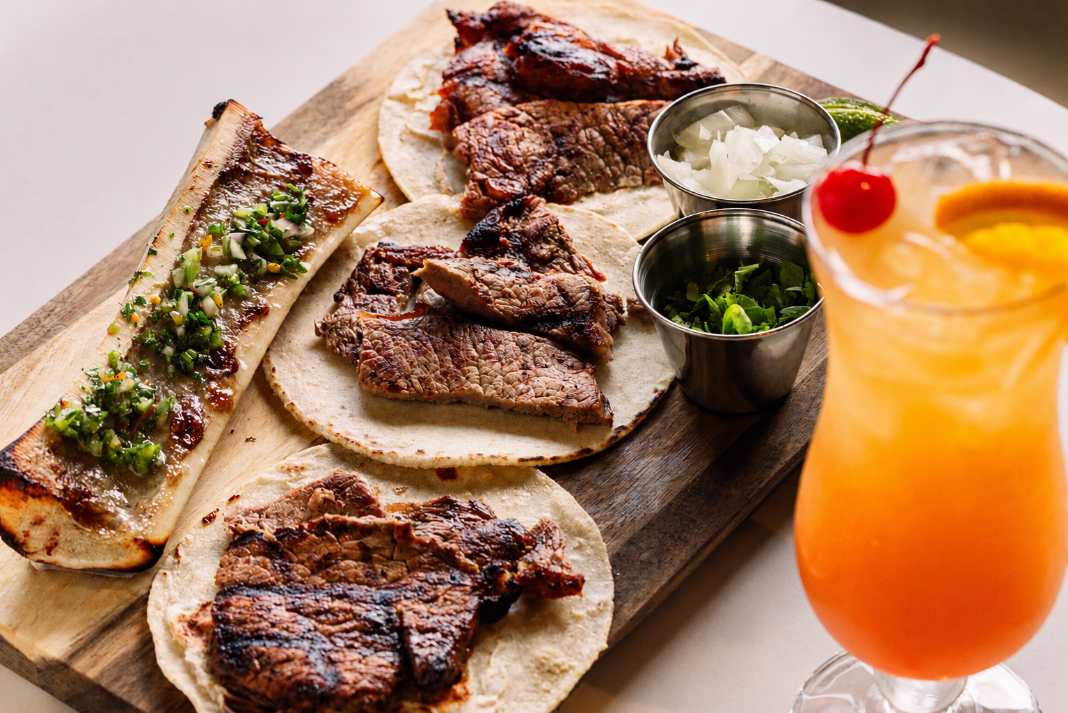 Grilled steak tacos with vibrant sides