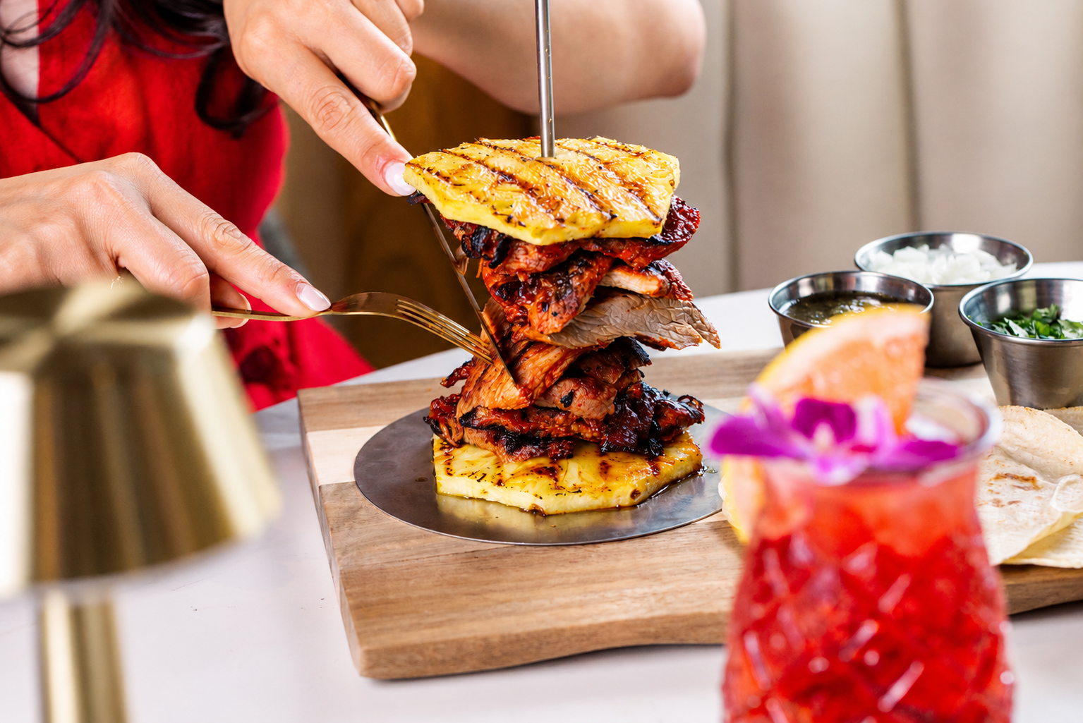 Slicing intro grilled meat and pinneaple